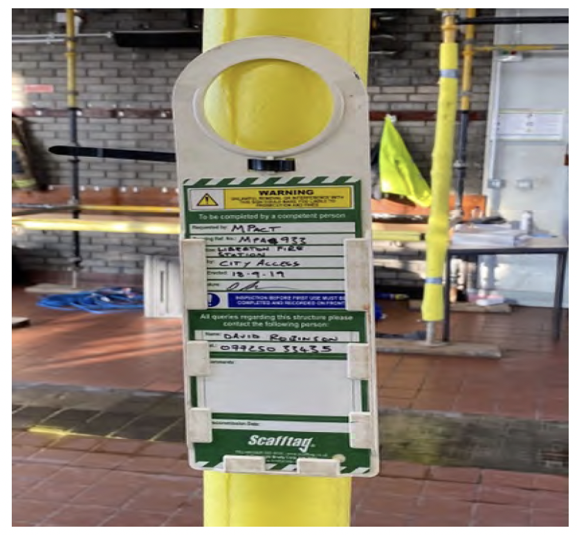 Image shows a detailed picture of one of the scaffold support information labels showing that it was installed on 18 September 2019.
