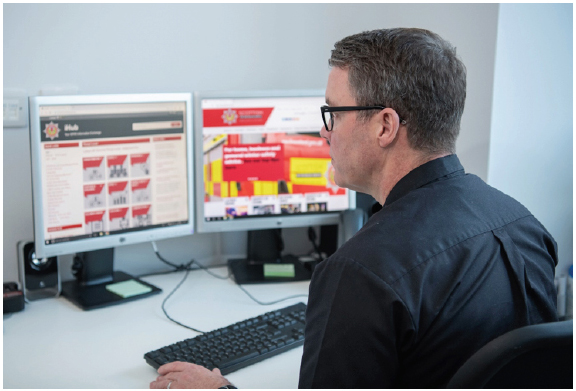 Figure 4: Image of individual working at a computer terminal - SFRS Corporate Communications